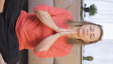 Vertical-video-of-Woman-meditating-looking-at-camera.